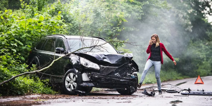 A woman who wrecked her black SUV into a tree